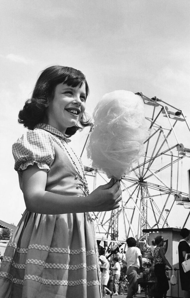 Mädchen mit Zuckerwatte vor Riesenrad - Deutscher Schaustellerbund e.V.